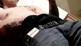 Tatted Kyd Cash chainsmoking while working his prick in his boxer shorts