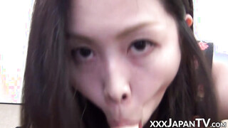 Handsome Oriental vixen stuffs mouth with plastic cock