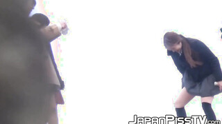 Four Japanese schoolgirls fool around outside before peeing