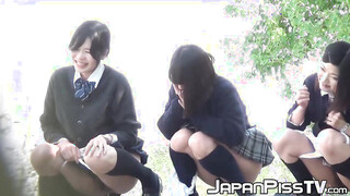 Three Japanese schoolgirls pissing hard together in public