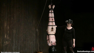 Strapped lesbian in inverted suspension