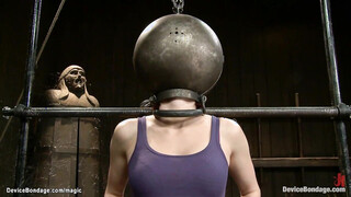 Bound redhead with head in metal ball