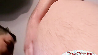 A bald black dude with a heavy prick rubbing it til he cums